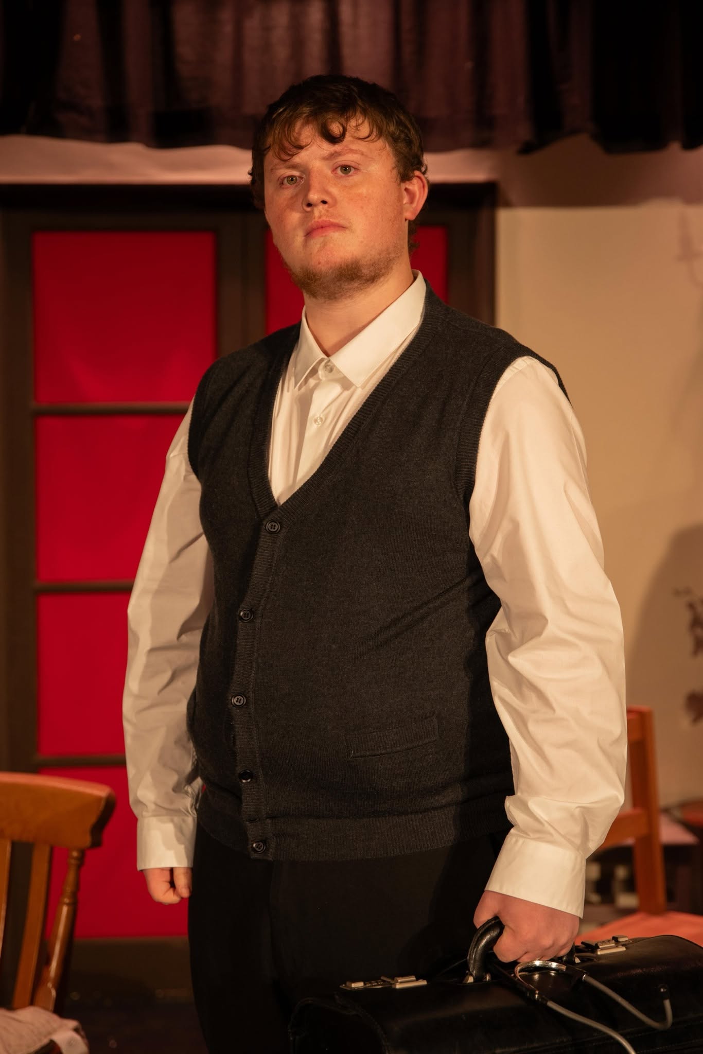 A Blithe Spirit cast member in a waistcoat carrying a doctor’s bag